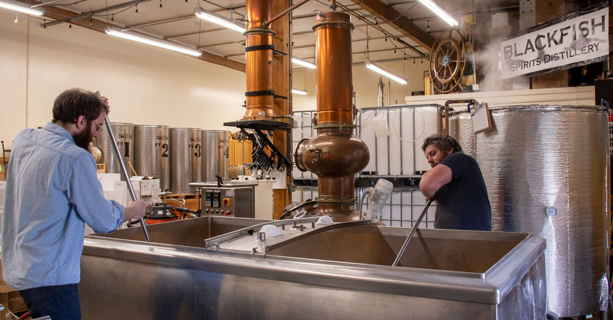 About Us - Distillery Tour 1 a man working in a factory