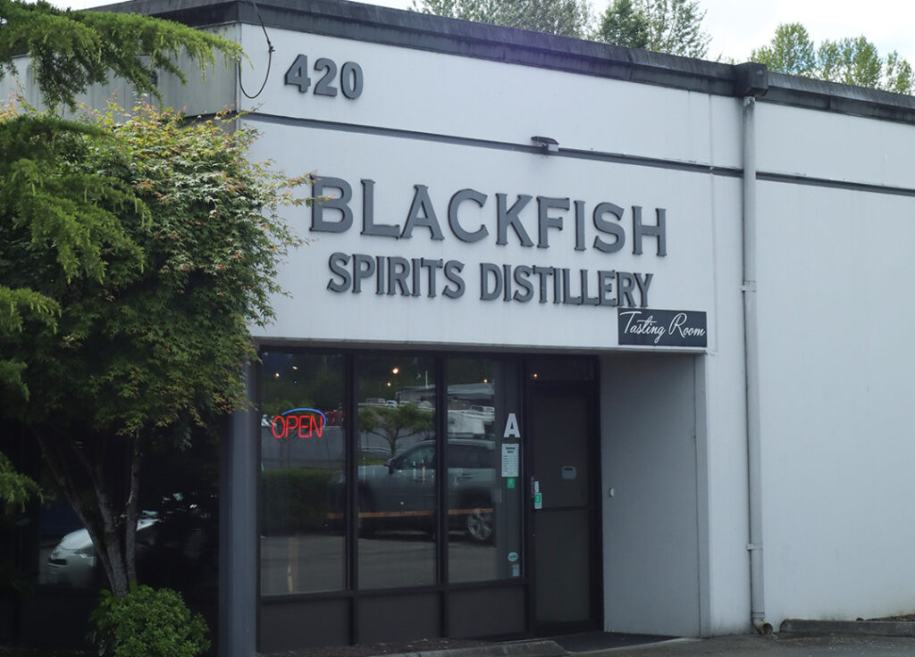 About Us - Distillery Tour 2 a building with a sign on the front